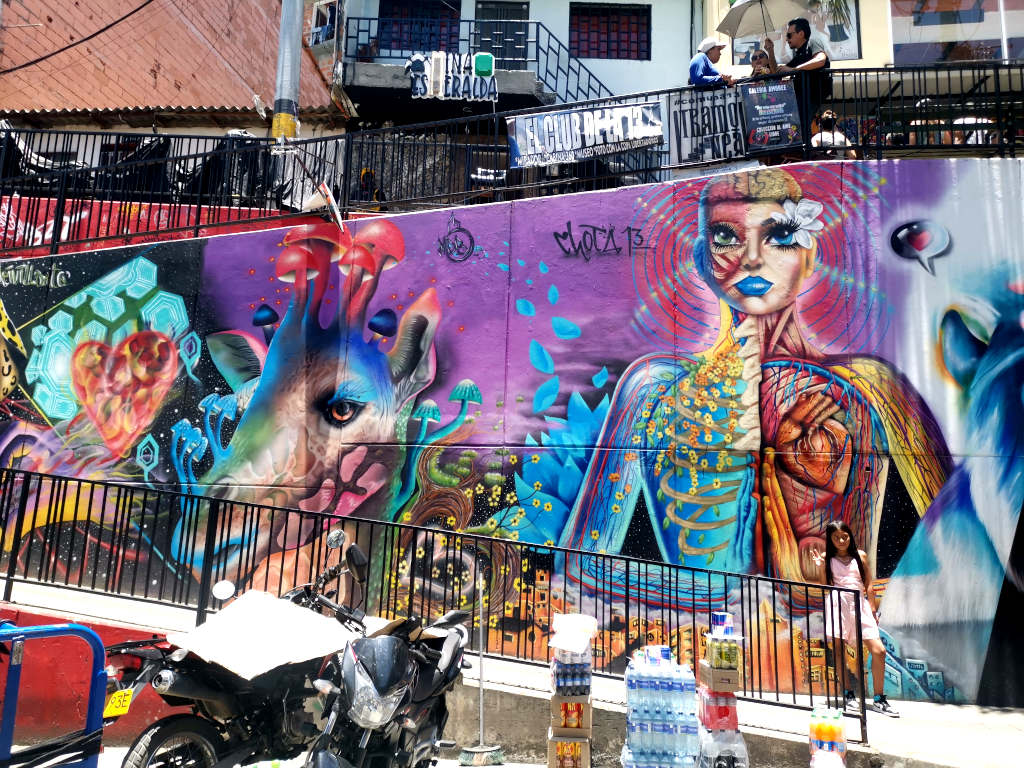 A colorful wall covered in street art at Comuna 13 one of the best free things to do in Medellin