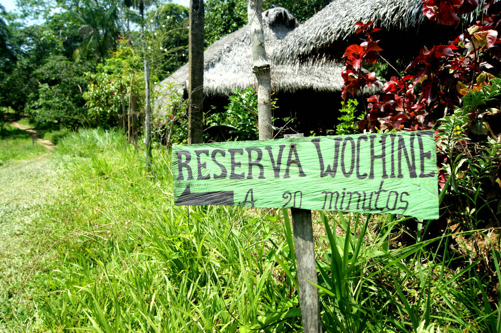 A sign pointing the way to Reserva Wochine near Puerto Narino