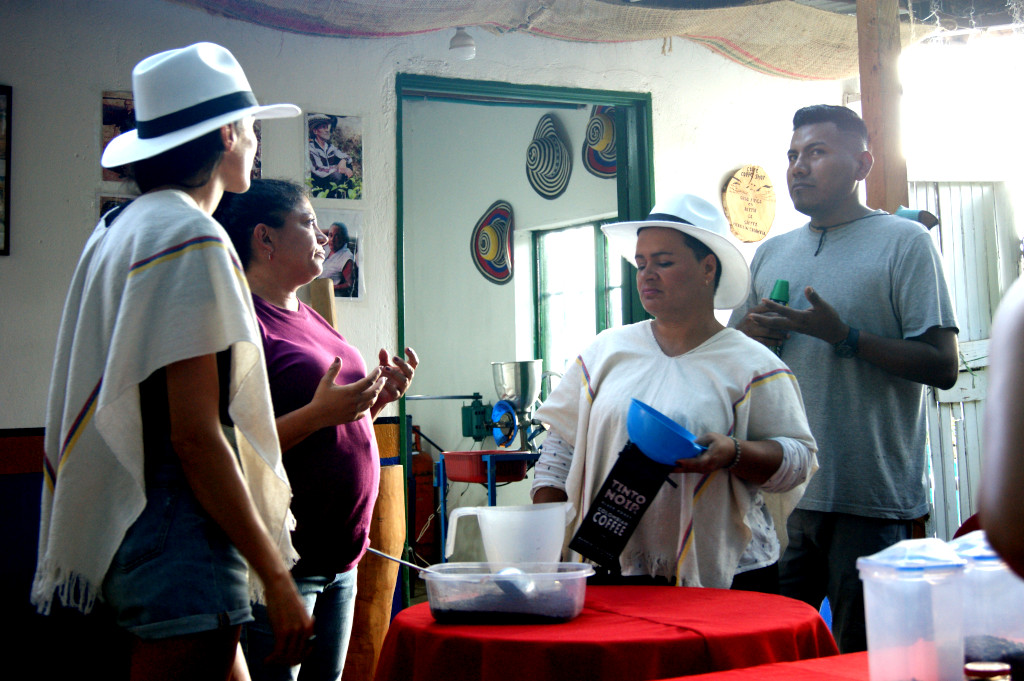 A tour guide talking about the coffee making process on a Medellin coffee tour