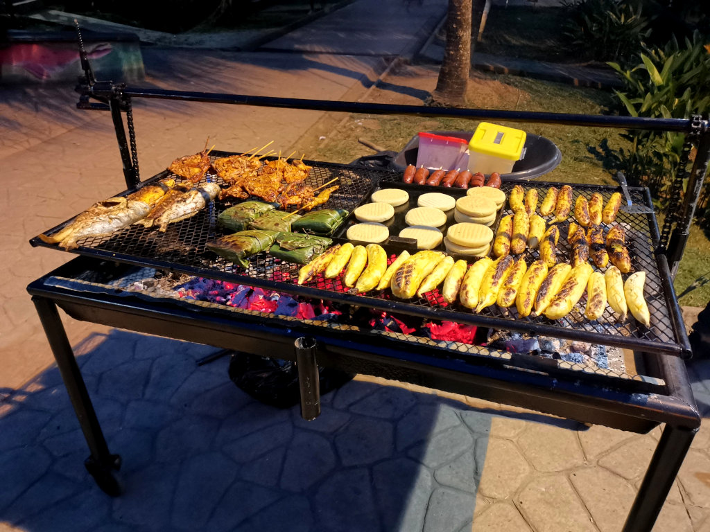 A street bbq with fish, plantain and arepas in Puerto Narino in the Amazon