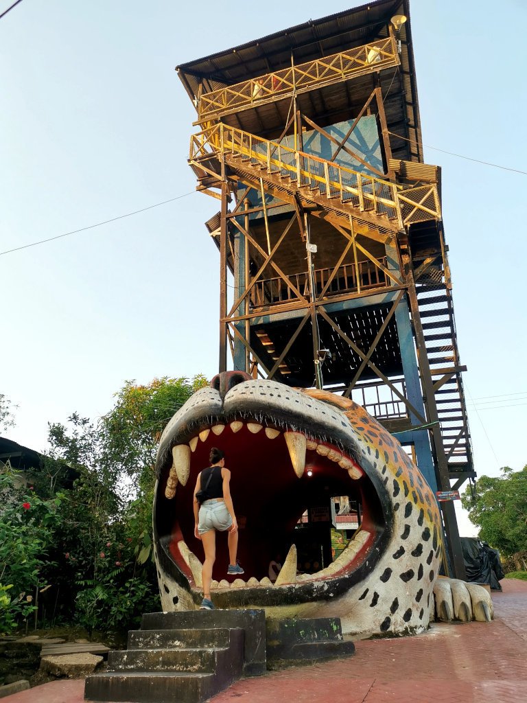 A woman walking into the entrance to a mirador in Puerto Narino that is shaped like the jaws of a jaguar