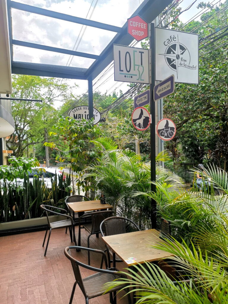 A Cafe in Laureles Medellin with lots of plants around it