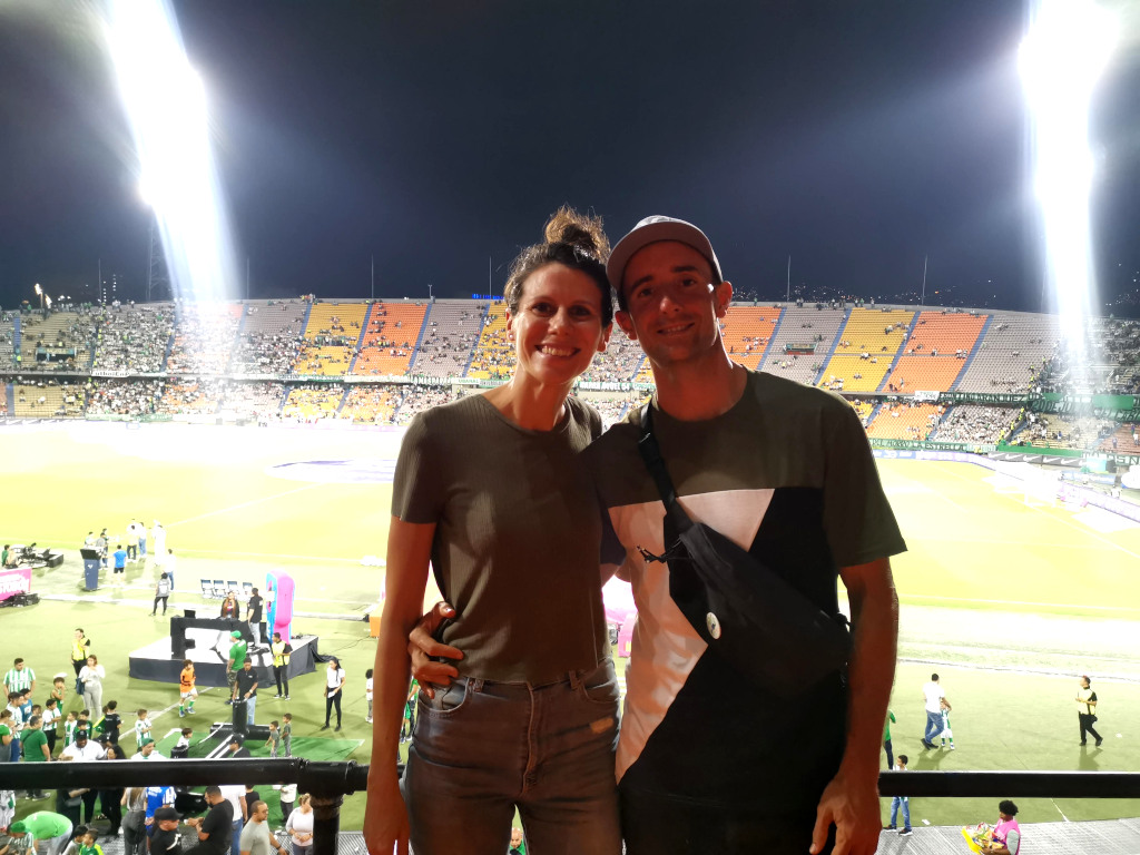 Two people standing in front of the soccer field in Laureles soccer stadium