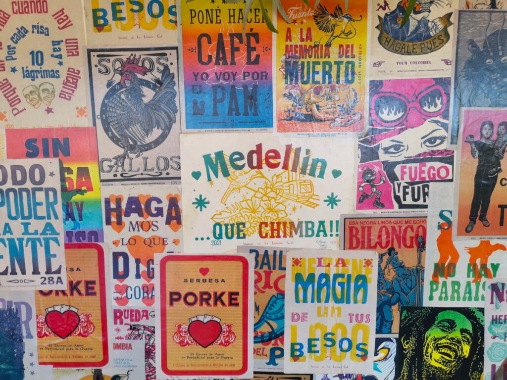 A colorful wall with posters in Laureles Medellin Colombia