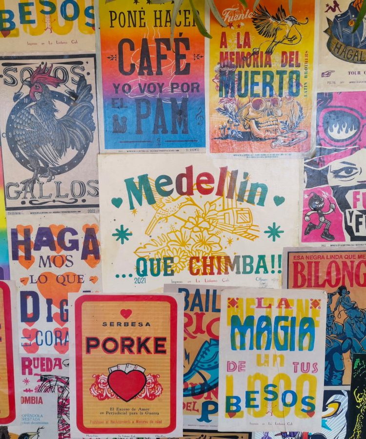 A colorful wall with posters in Laureles Medellin Colombia