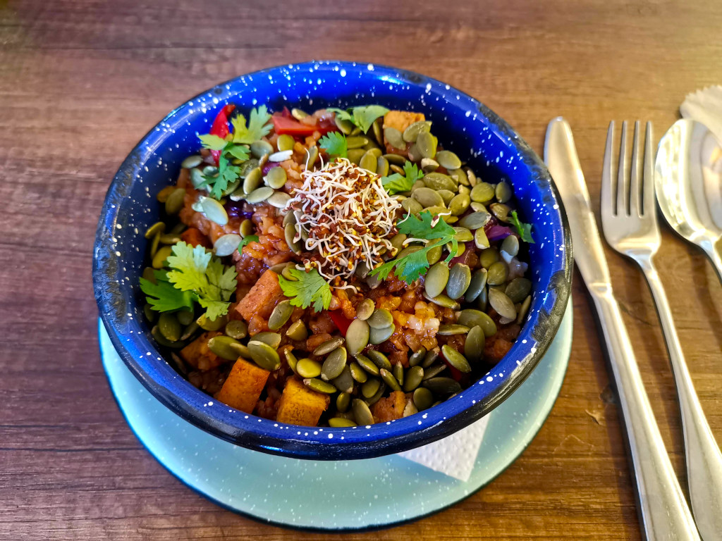 A tofu bowl with seeds and sprouts on the top at a restaurant in Guatape Colombia