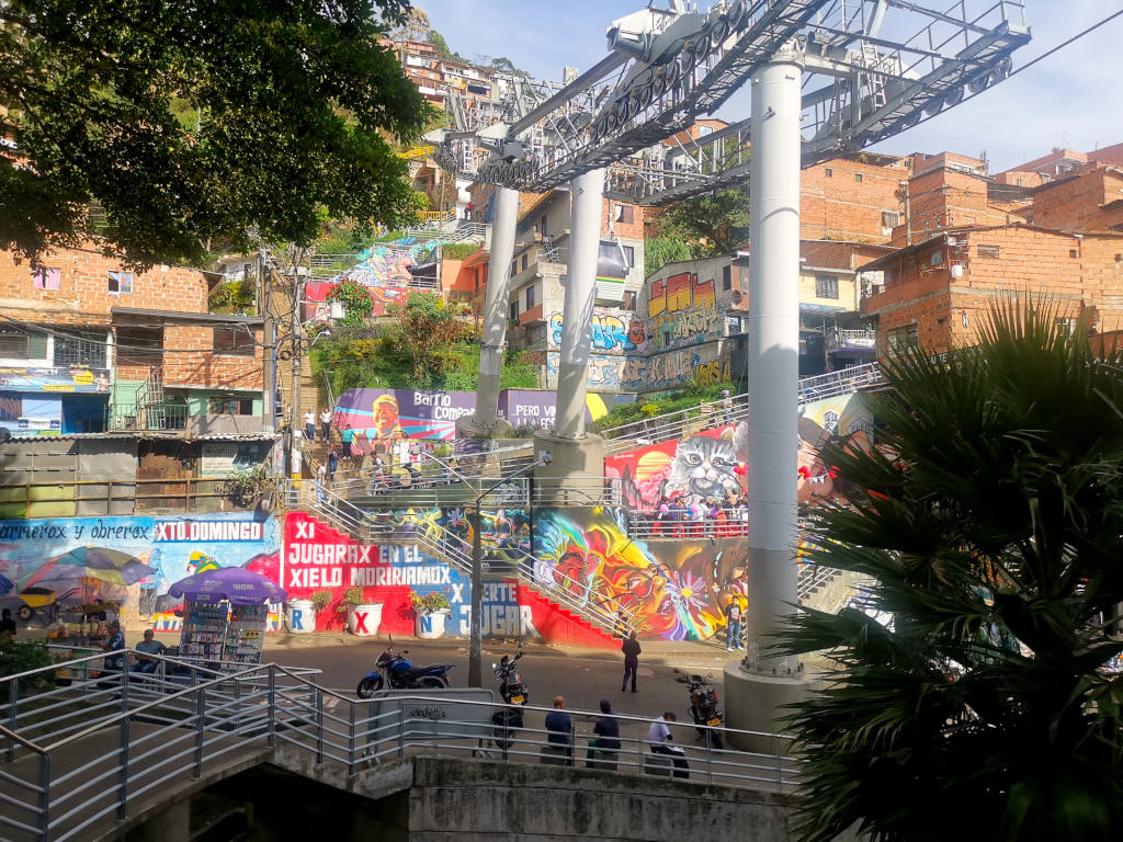 A cable car station in Medellin with colorful street art on the walls