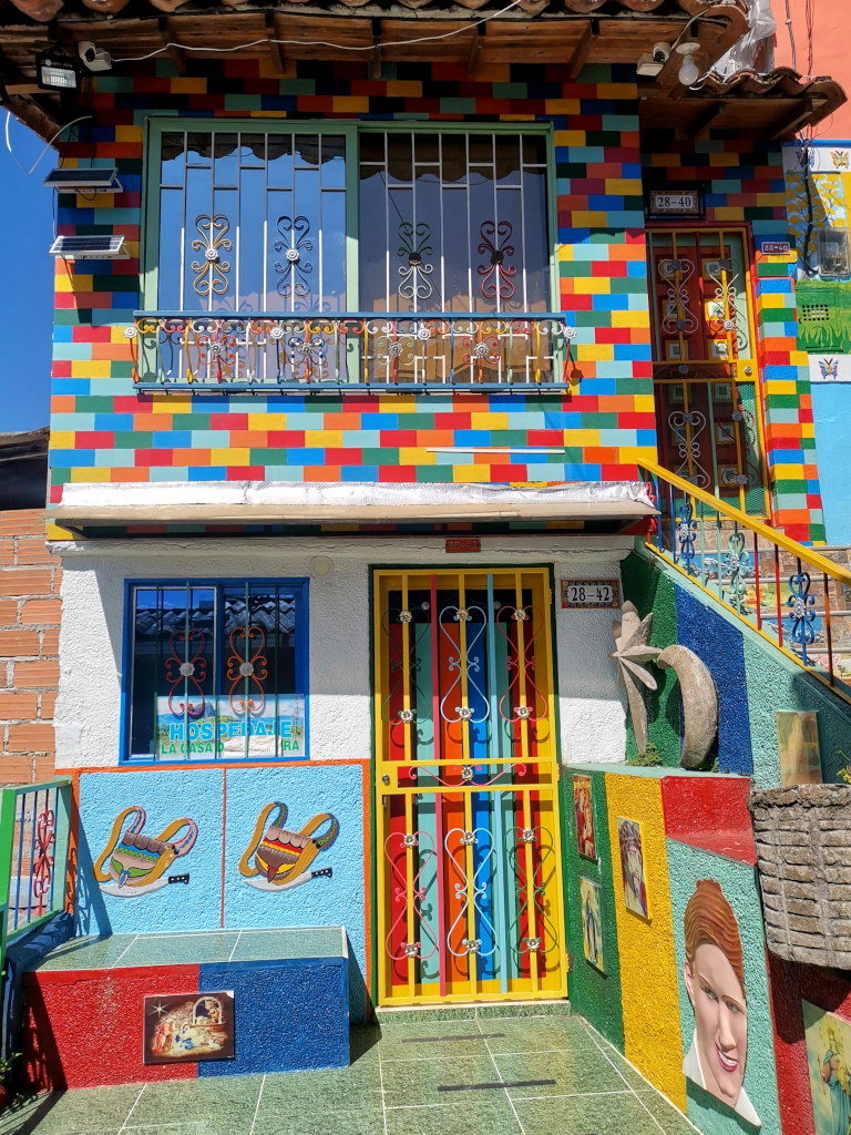 A colorful house with zocolos sticking out from the walls