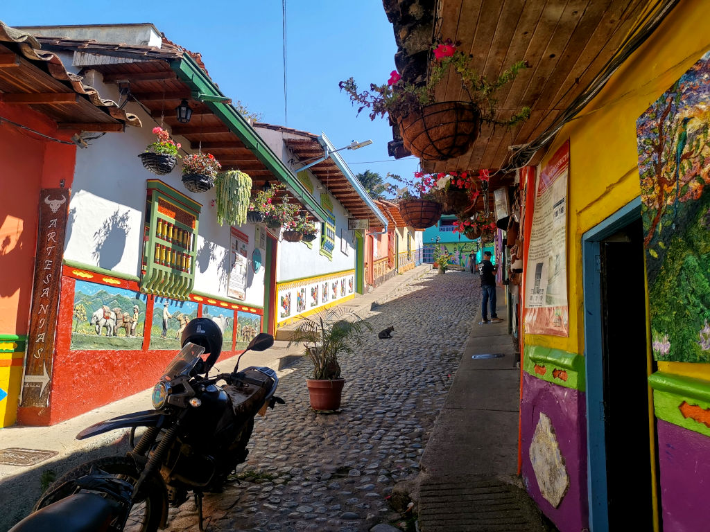 A colorful street with a motorcycle in Guatapé