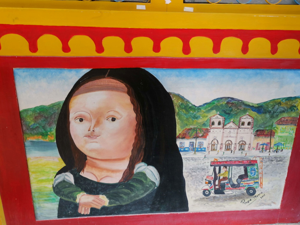 A Botero figure painted on a zocolo on a wall