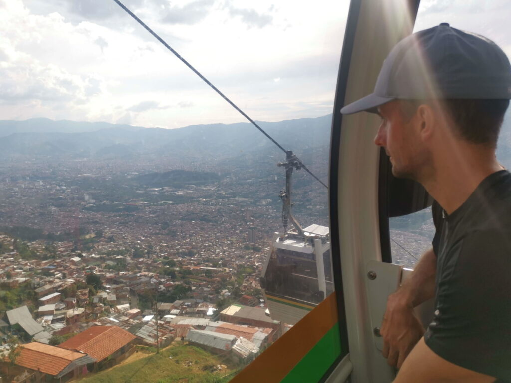 A man looking outside a cable car, the best way how to get to Parque Arvi