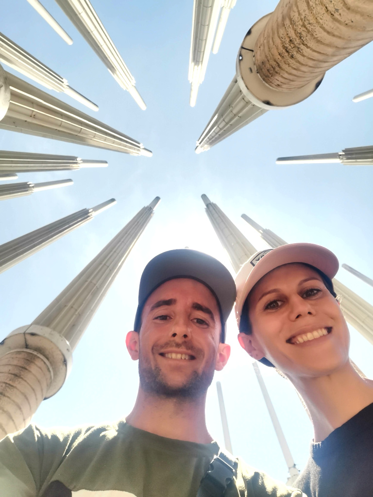 A couple taking a selfie with light poles in the background