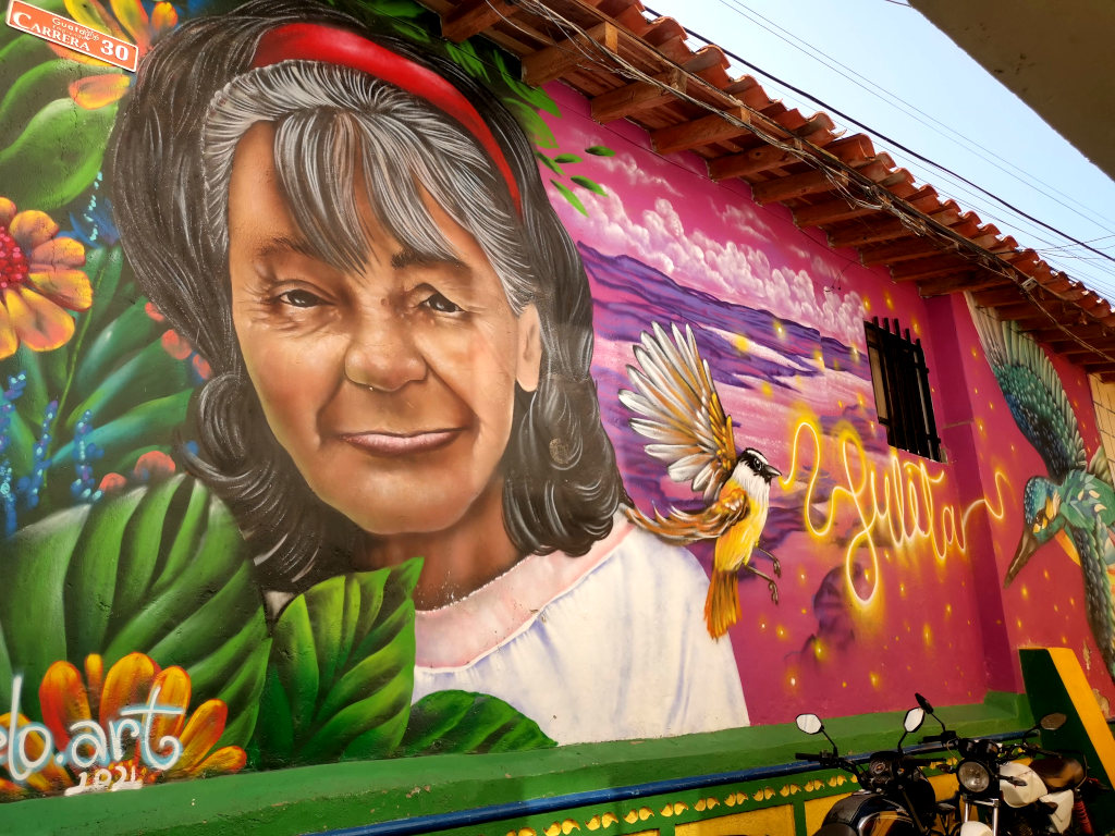 Street art of an old woman on a wall in a small town in Colombia