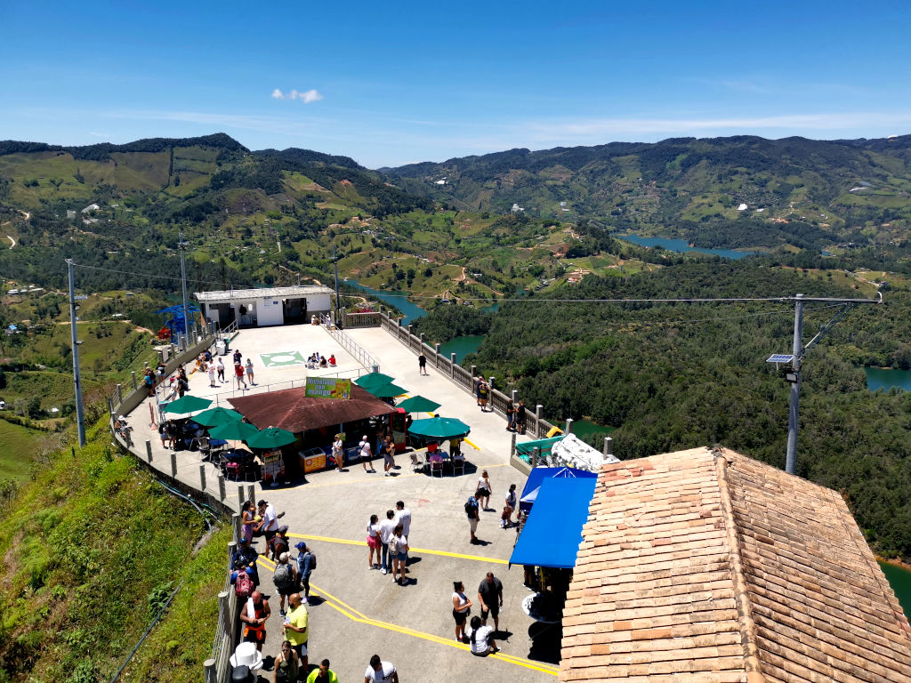 The top of El Peñol with a group of people enjoying the view and sitting outside cafes one of the top things to do in Guatape