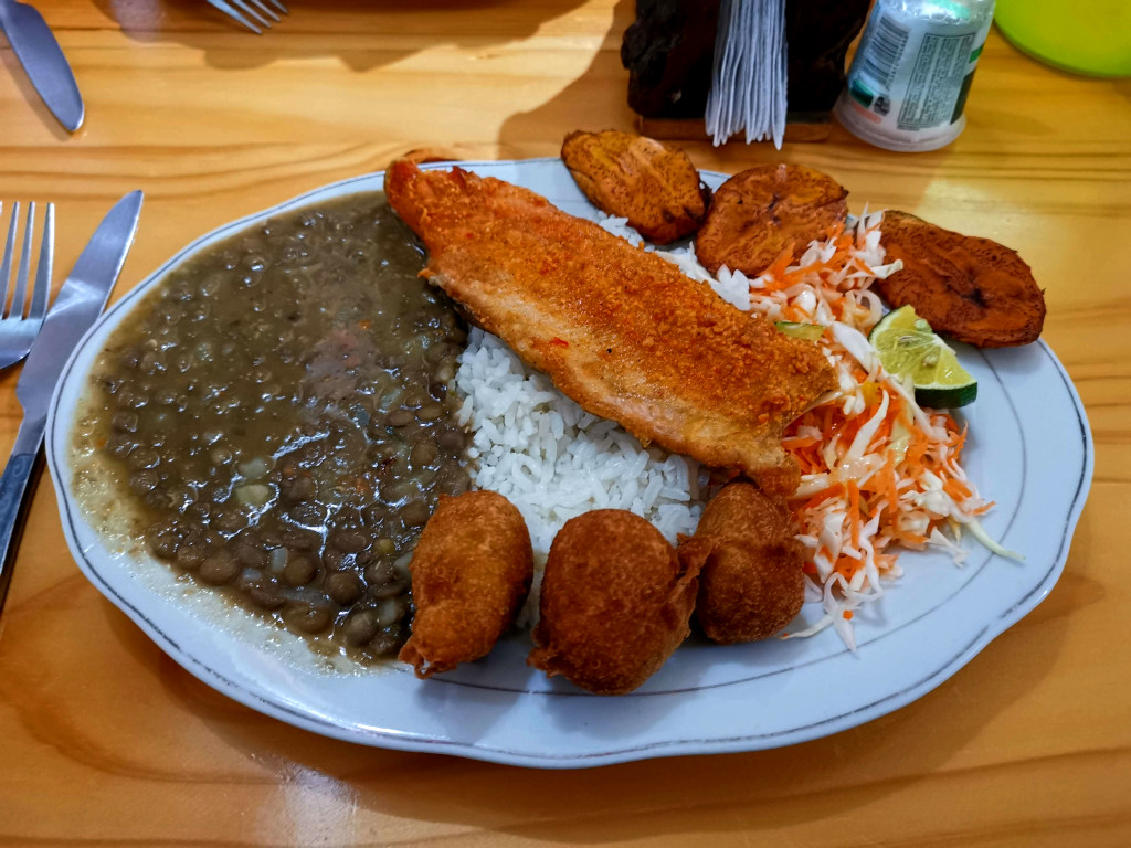 A plate of lentils and rice with a piece of trout on top at el rincon de luci one of the cheapest restaurants in Salento