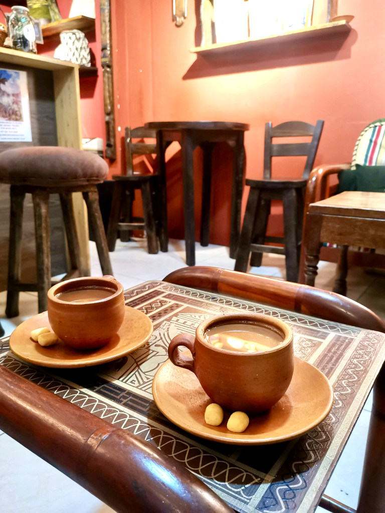 Two cups of hot chocolate on a table at a cafe in salento colombia