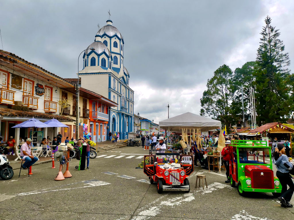 The colorful main square of Filandia in Colombia with a Sunday market toaking place one of the best things to do in Salento 