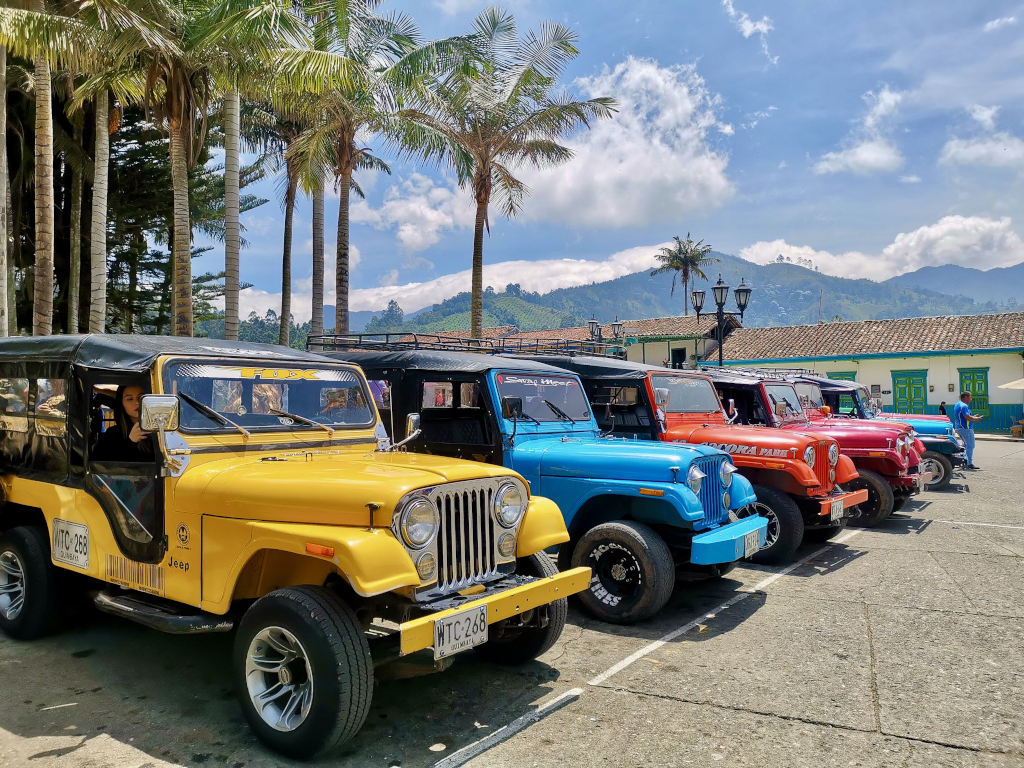A group of colorful jeeps parked in a line taking a ride in them is one of the best things to do in Salento