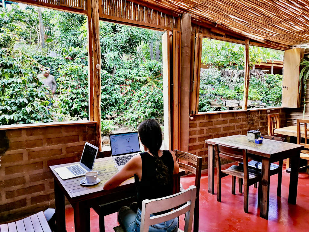 A woman working on her laptop at cafe san juan at lake atitlan