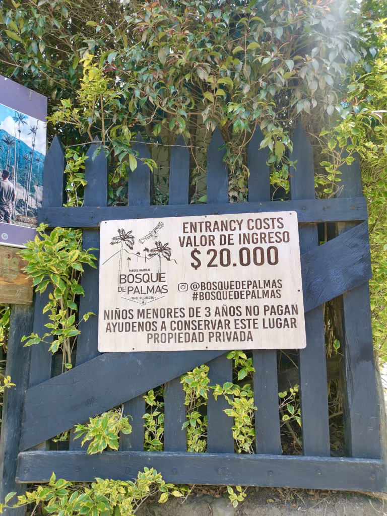 A sign stating the cocora valley hike entrance fee