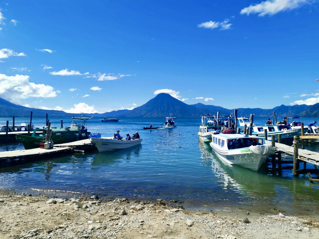 A group fo boats sitting at the docks of panajachel at lake atitlan