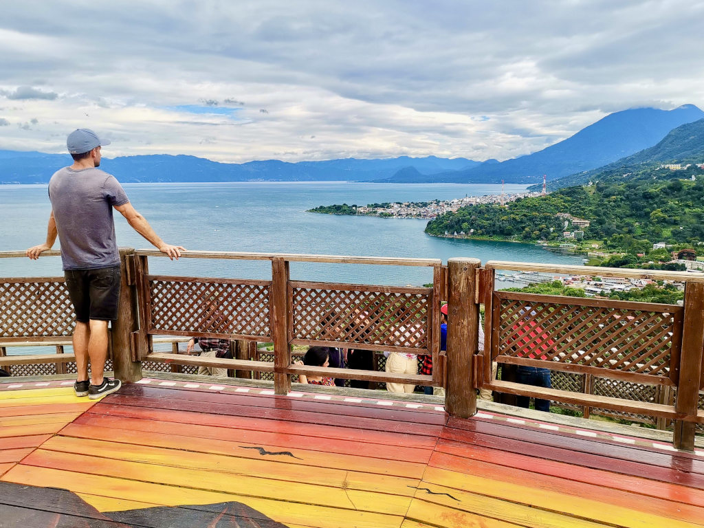 A man looking at at the view from the mirador near san juan la laguna