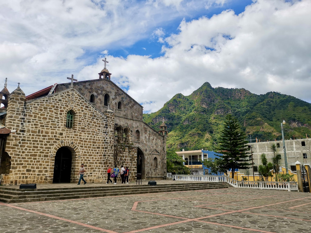 A grey concrete church at the main square of san juan la laguna 