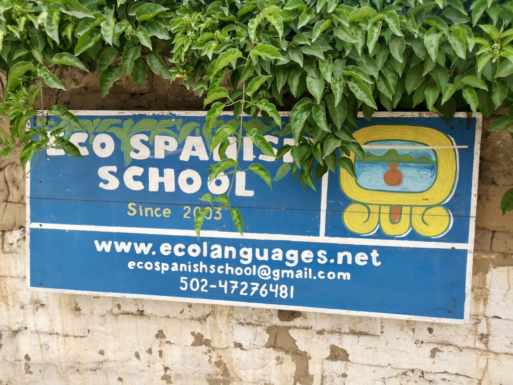 A sign advertising Eco Spanish School in San Juan La Laguna