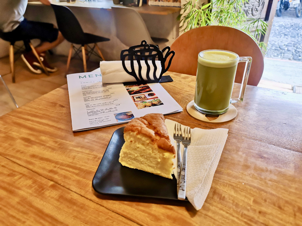 A plate with cheesecake and a cup of matcha tea at one of the best cafes in Antigua Guatemala