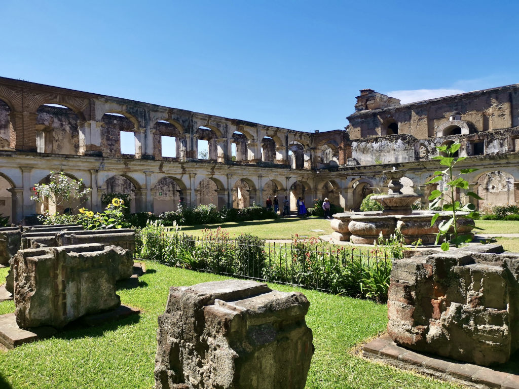 A grassy courtyard of an old Covent that is full of history and one of Antigua Guatemala ruins