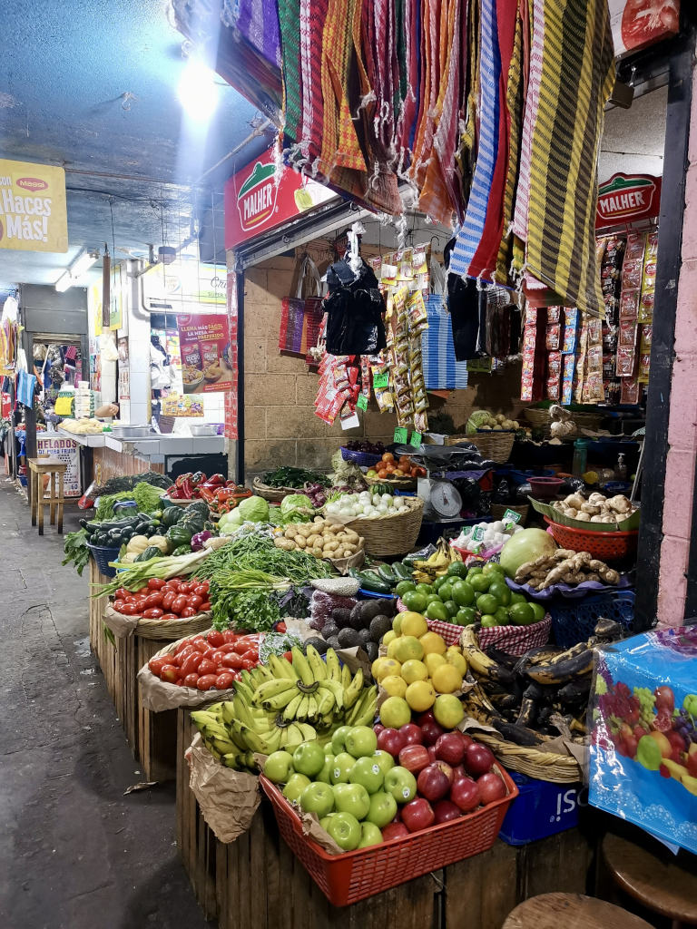 A selection of fresh produce in bowls and baskets at a market in Antigua Guatemala