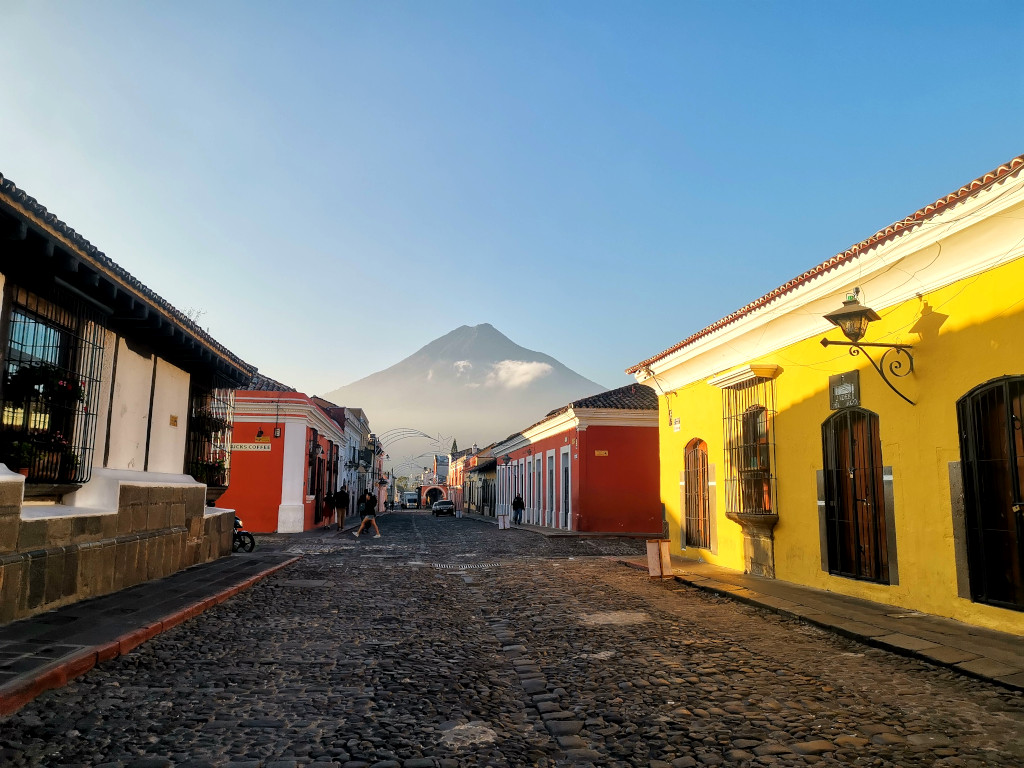 The sun rising in Antigua's town with a clear view of Agua Volcano - one of the best cheap things to do in Antigua Guatemala