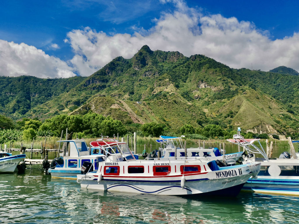 A boat on Lake Atitlan in Guatemala with some green mountains in the background