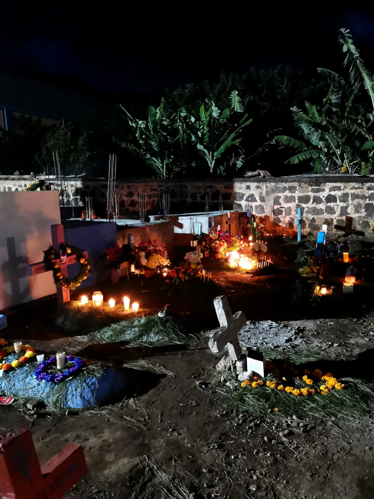 Graves lit up with cancles at Dias de los Muertos in Guatemala