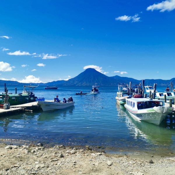 A group of boats on the water next to the docks at Panajachel the best place how to get from Guatemala City to Lake Atitlan