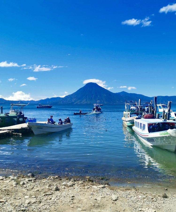 A group of boats on the water next to the docks at Panajachel the best place how to get from Guatemala City to Lake Atitlan