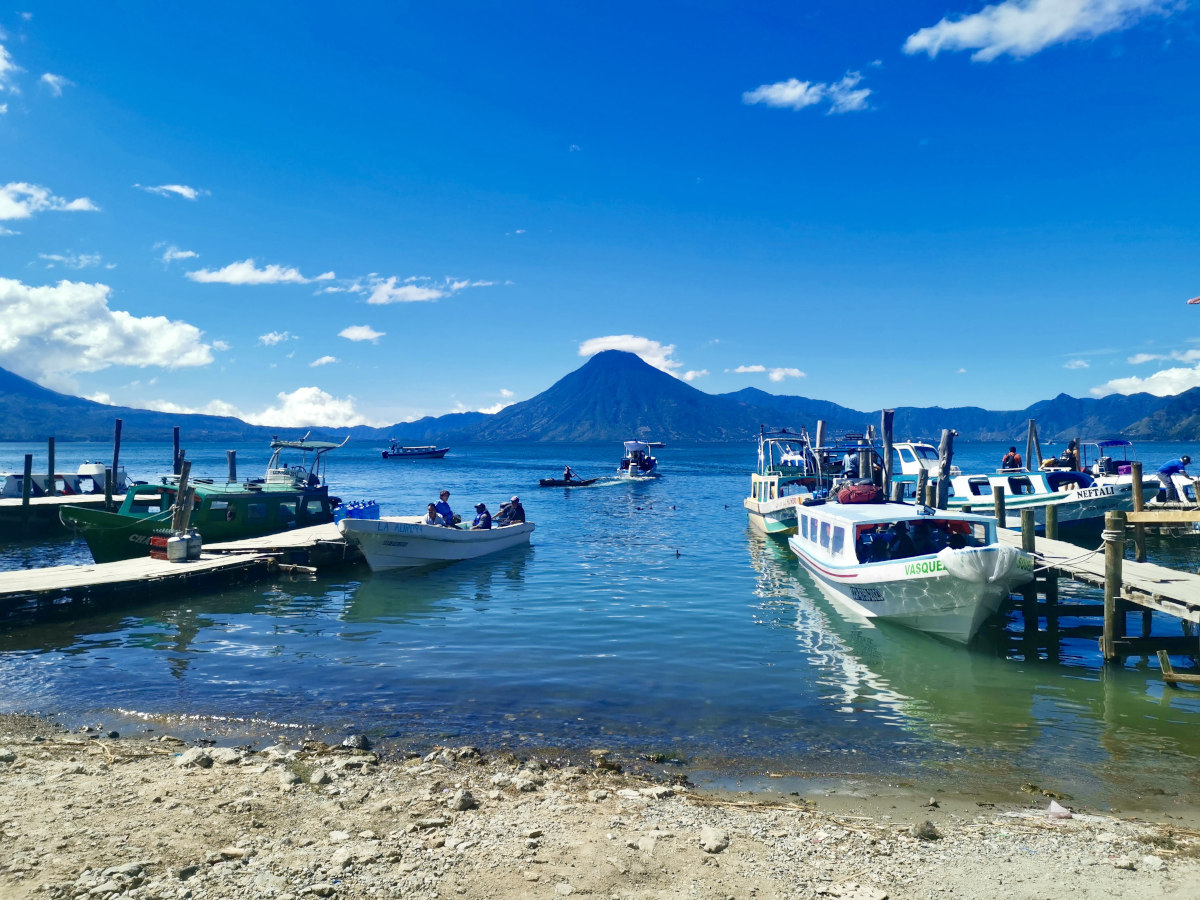 A group of boats on the water next to the docks at Panajachel the best place how to get from Guatemala City to Lake Atitlan