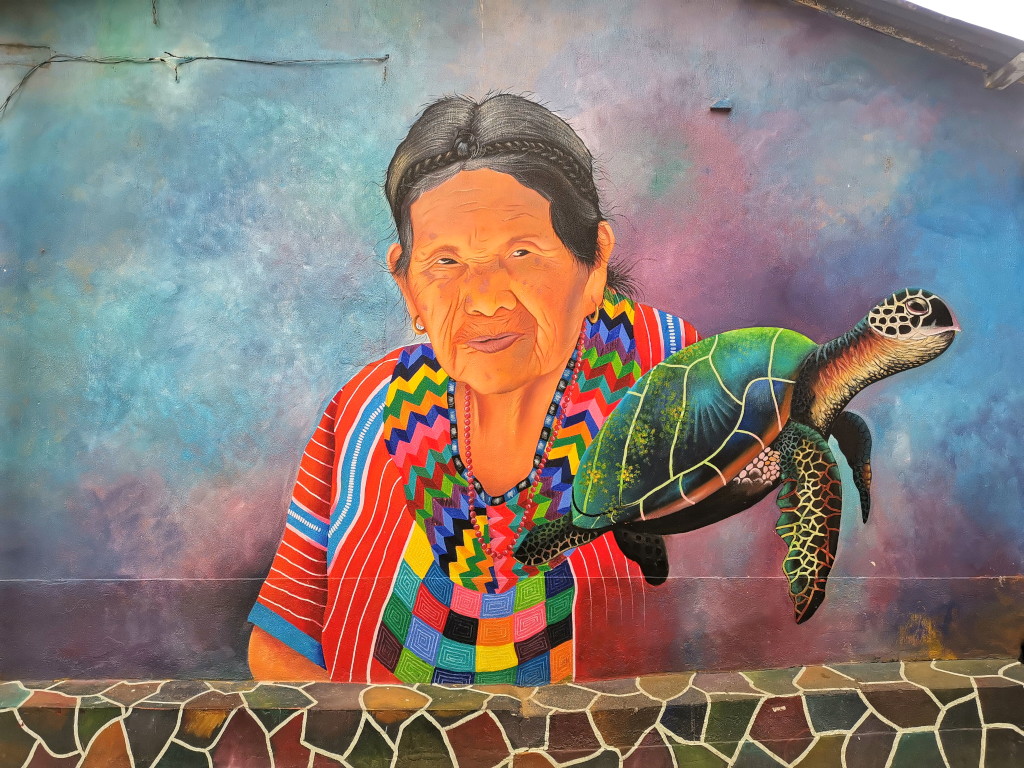 Colorful mural in San Juan La Laguna showing a local women in a traditional dress and a sea turtle