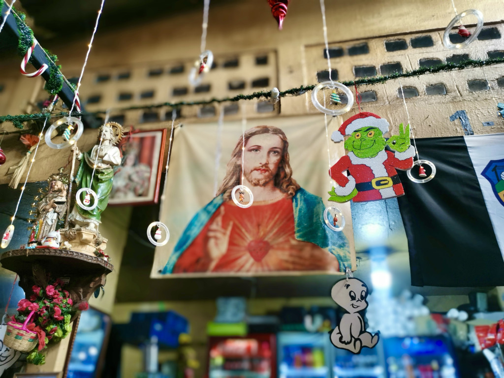 Christmas decoration hanging from the ceiling at Antigua's main market with an image of Jesus in the background