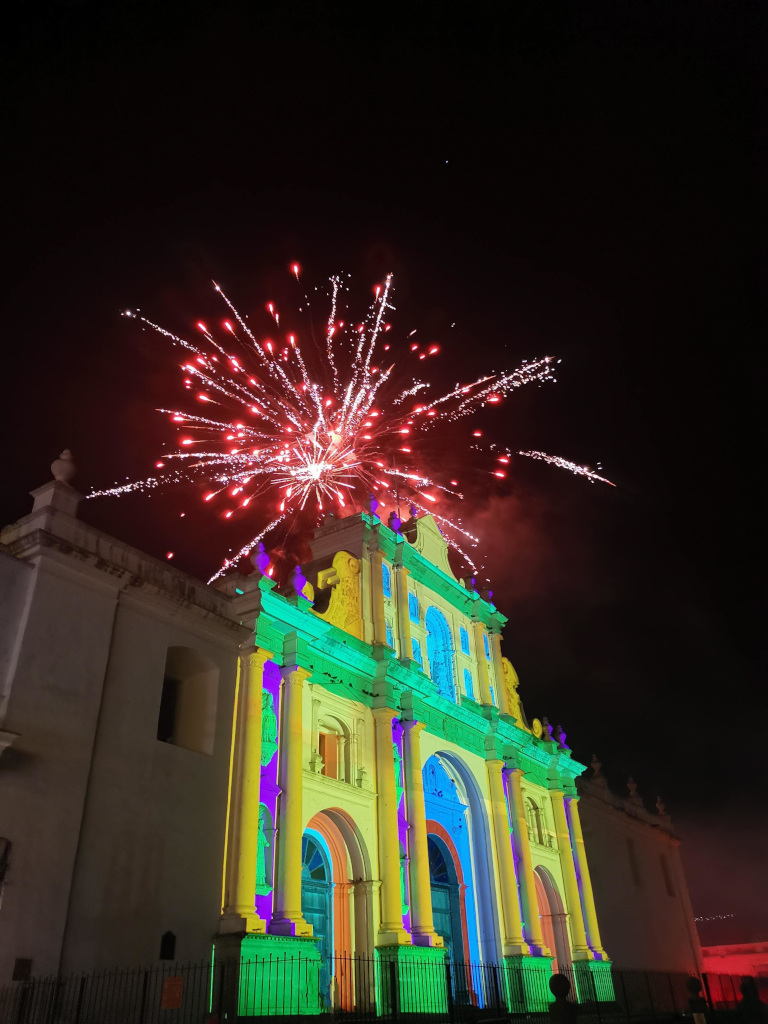 Red fireworks at night above Antigua's church on the main square