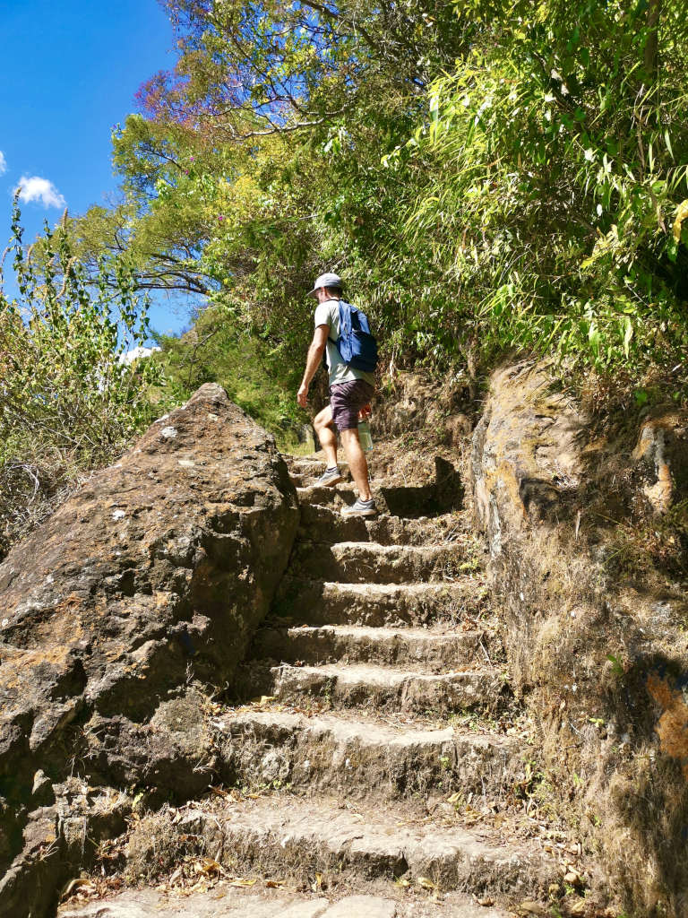 A man walking up stairs on the Lower Mayan Trail one of the best hikes at Lake Atitlan