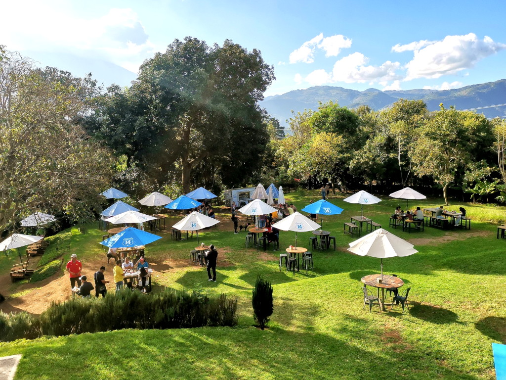Outdoor area of Cerveceria 14 in Antigua Guatemala with tables and umbrellas
