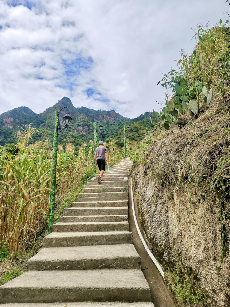 A man walking up the stairs that lead up to the San Juan La Laguna Mirador