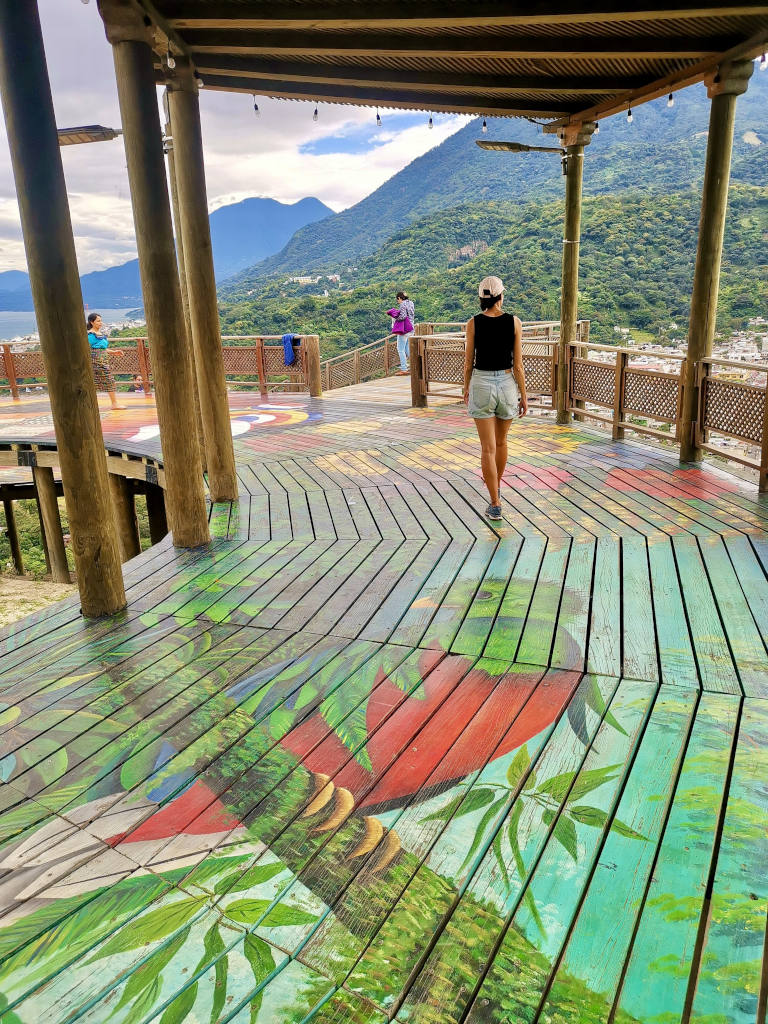 A woman walking along a colorful lookout in Guatemala