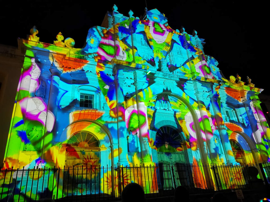 A church covered in a colorful light display during New Years Eve Antigua Guatemala