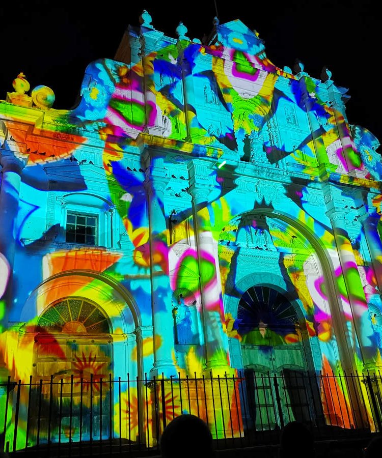 A church covered in a colorful light display during New Years Eve Antigua Guatemala