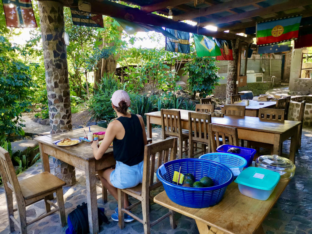 A woman eating at a restaurant in Jaibalito under the shade 