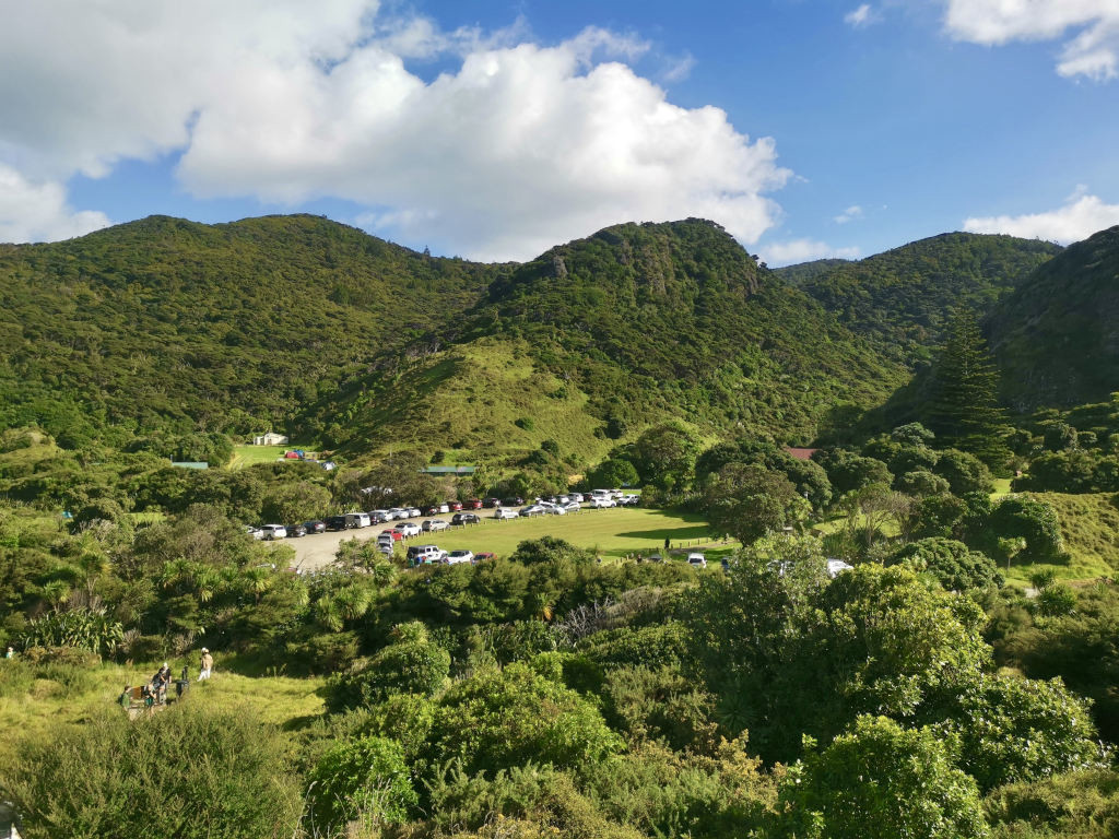 The Omanawanui Track car park surrounded by green hills