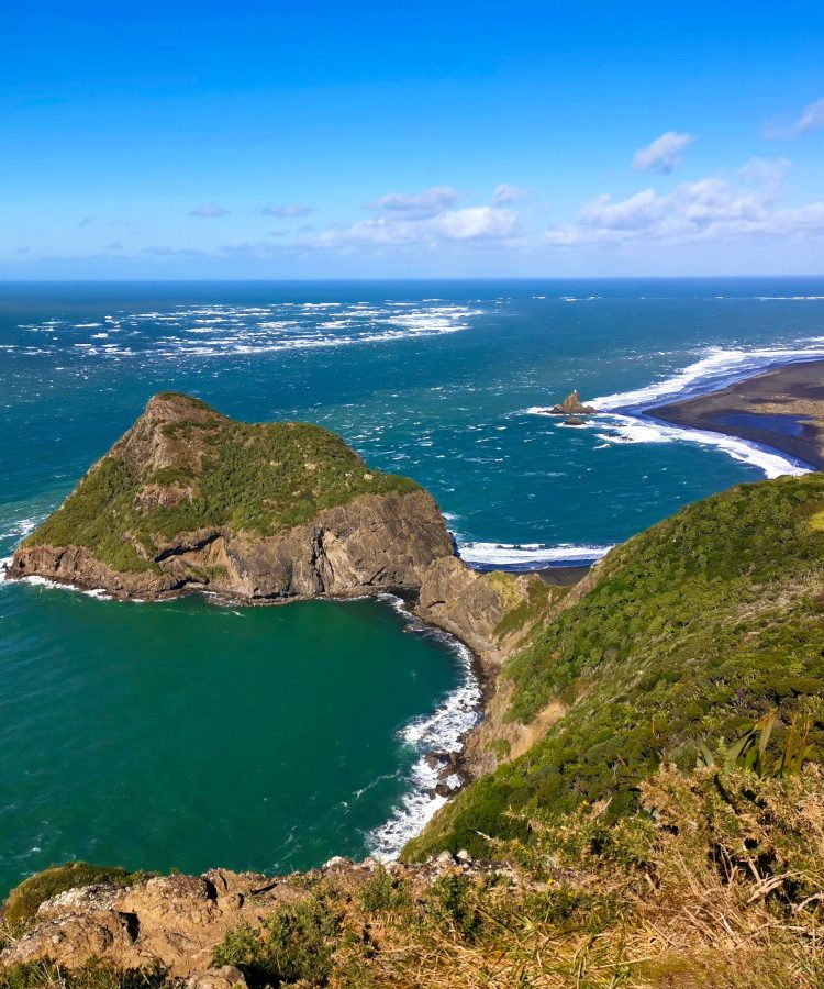 The Omanawanui Track ridge walk with views over the path snaking along the coast