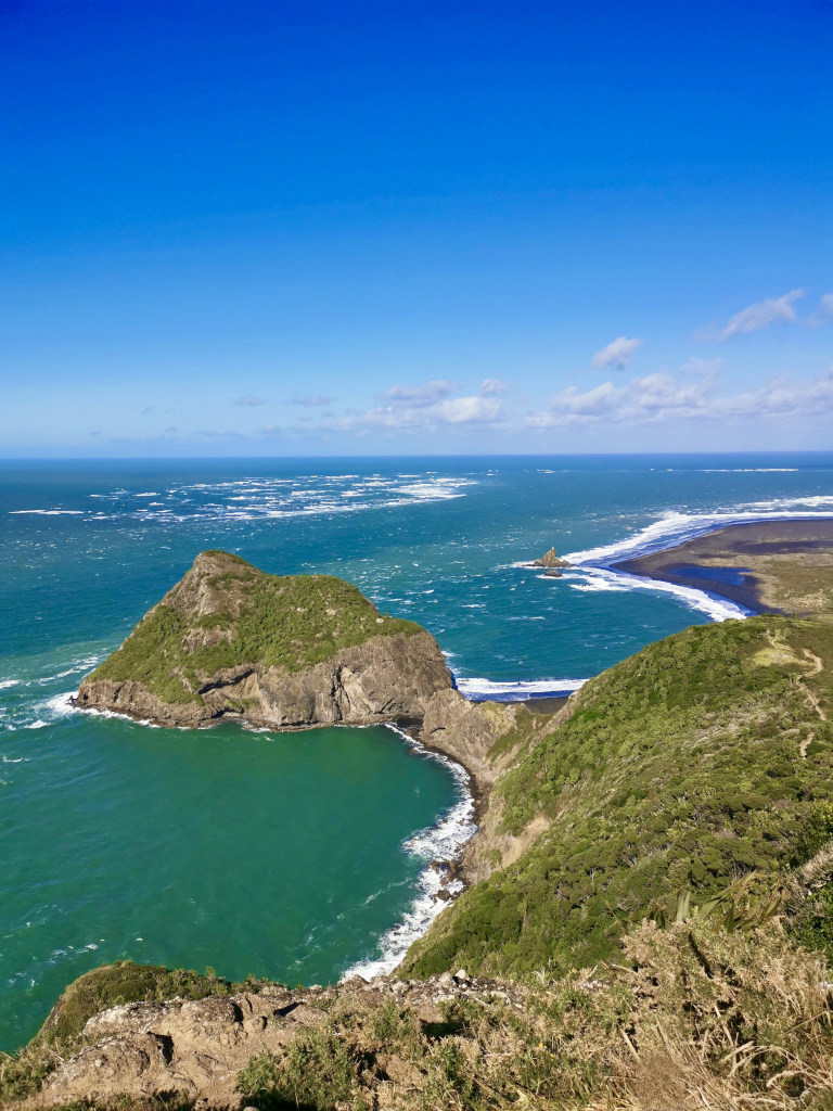 A rocky point surrounding by stormy seas on the west coast of Auckland in the Waitakere Ranges Regional Park